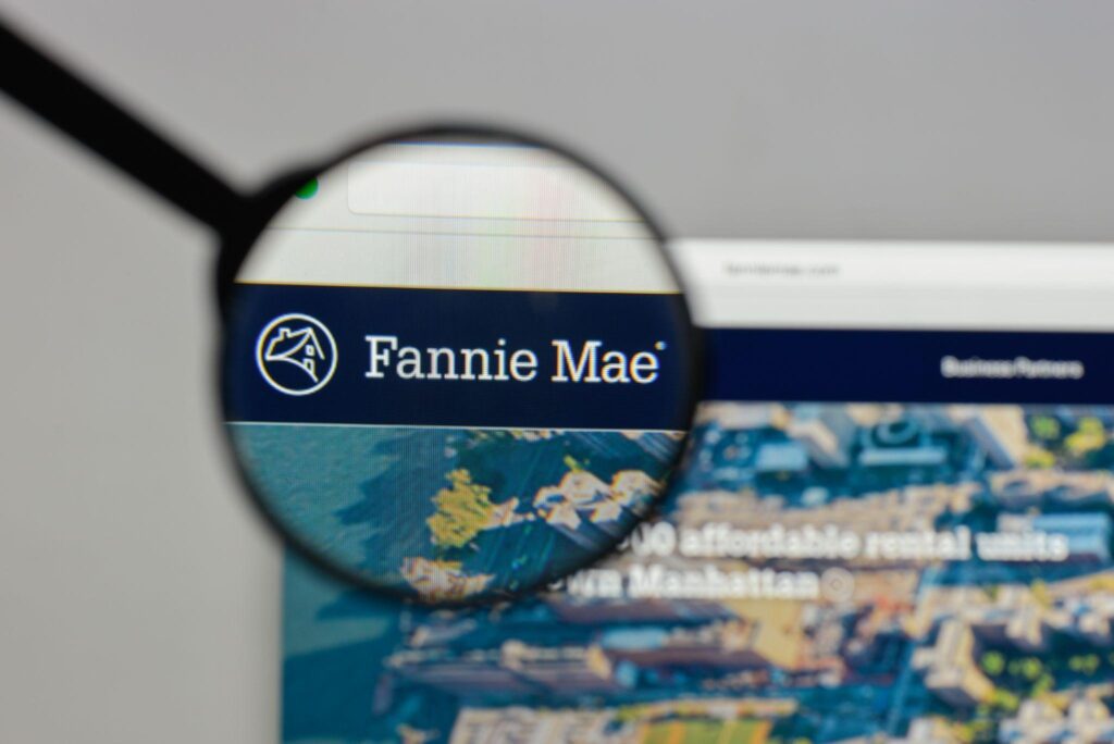 A magnifying glass focuses on the “Fannie Mae” logo on their website.